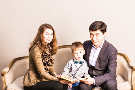 friendly family reading book on Christmas evening