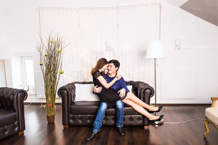 Christmas Couple.Happy Smiling Family at home celebrating.New Year Peopleの写真素材