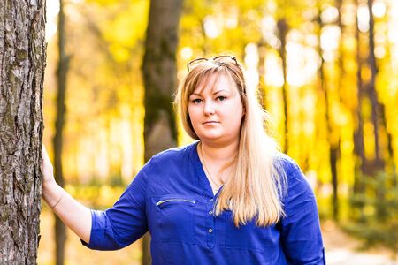 Nice pretty young woman in autumn park