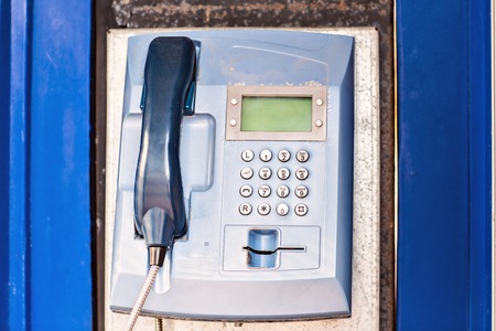 Public Payphone. blue phone box in a phone boothの写真素材