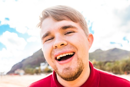 Smiling man at the seaside. Crazy happy man