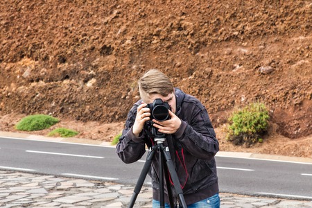 photographer taking photo in wild. Photographer works