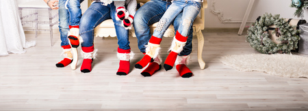 Closeup photo of family feet in wool socks.の写真素材