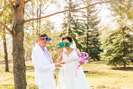 a young wedding couple  in funny big glassesの写真素材