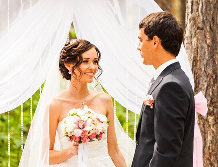 Couple Getting Married at an Outdoor Wedding Ceremony.の写真素材