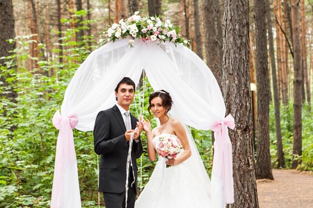 Couple Getting Married at an Outdoor Wedding Ceremony.の写真素材
