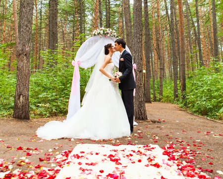bride and groom near the wedding arch.の写真素材