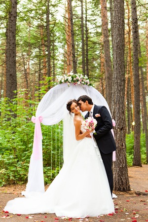 bride and groom near the wedding arch.の写真素材