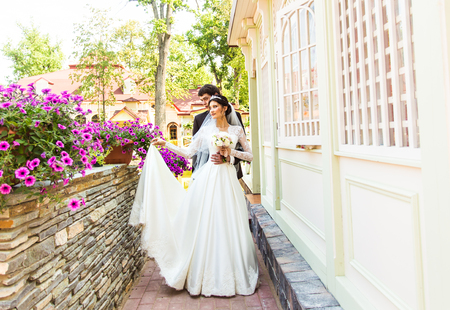 Bride and groom having a romantic moment on their wedding day.の写真素材