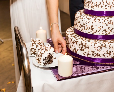 bride and groom is cutting their wedding cake.の写真素材