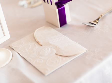 Paper wedding invitation on the white tableの写真素材
