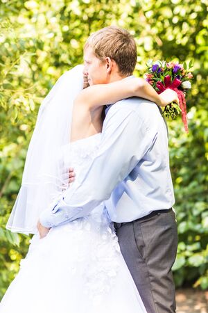 Cheerful married couple. bride and groom embracingの写真素材