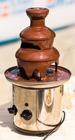 Chocolate fountain placed on a table in wedding day.の写真素材