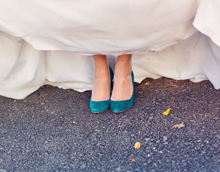 Bride  show off her turquoise shoes at wedding.の写真素材