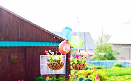 Hanging Flower Pots with fence. yard of a country houseの写真素材