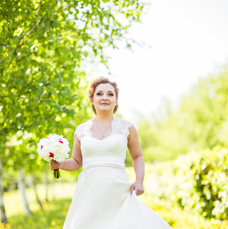 portrait of young bride in the spring garden.の写真素材