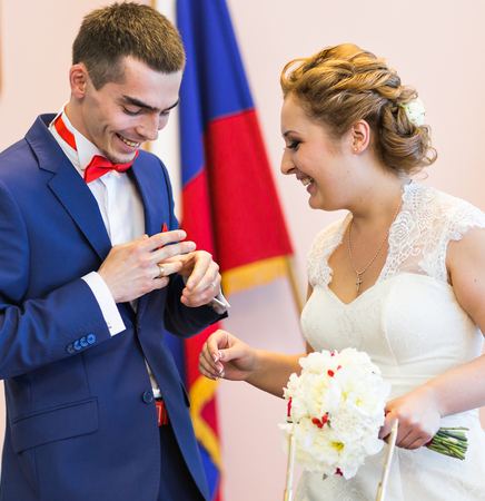 The groom wears the ring . Wedding ceremonyの写真素材