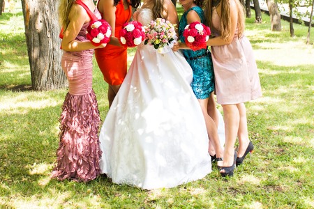 Bride and bridesmaids in row. Bridesmaids with bouquets.の写真素材