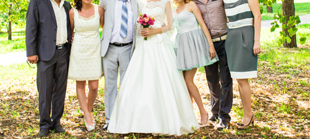 The bride and groom, and guests in a parkの写真素材