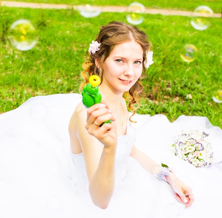 Bride play with soap-bubble and joy smile.の写真素材