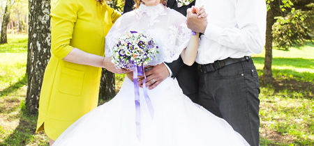 Wedding guests.  bride with her mother and father outdoorの写真素材