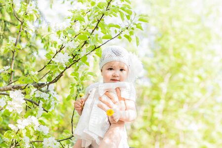Cute smiling baby girl outdoors. Baby in a parkの写真素材