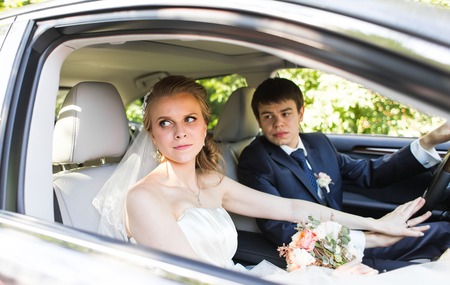Bride and groom inside a  car. They are happyの写真素材