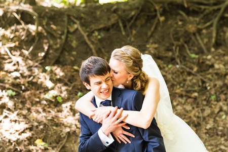 Wedding, Beautiful Romantic Bride and Groom Embracing outdoorsの写真素材
