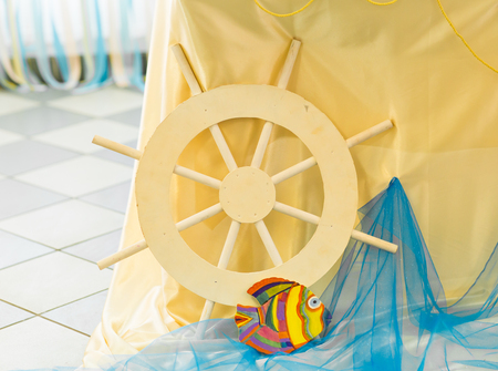 maritime style reception decor. yellow ships wheelの写真素材