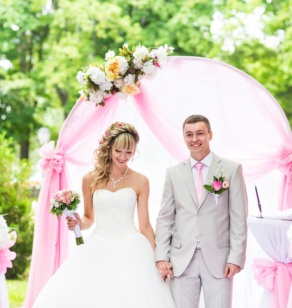 creative stylish wedding ceremony elegant blonde bride and groom outdoorsの写真素材