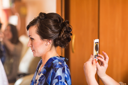 Woman taking picture of her girlfriend hairstyle.の写真素材