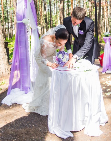 Wedding ceremony. Wedding couple leaving their signatures.の写真素材