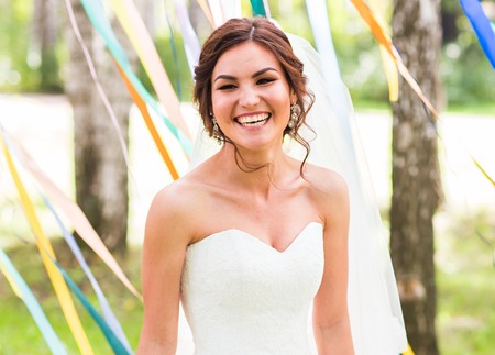 Beautiful bride outdoors in a forest. Pretty womanの写真素材
