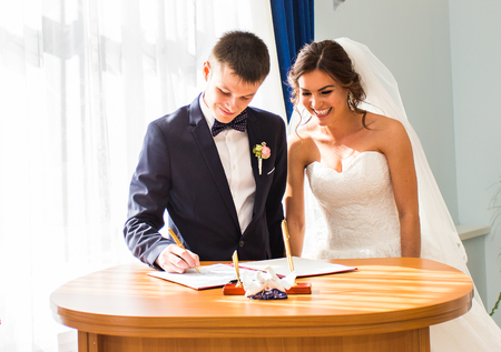 Wedding ceremony. Wedding couple leaving their signatures.
