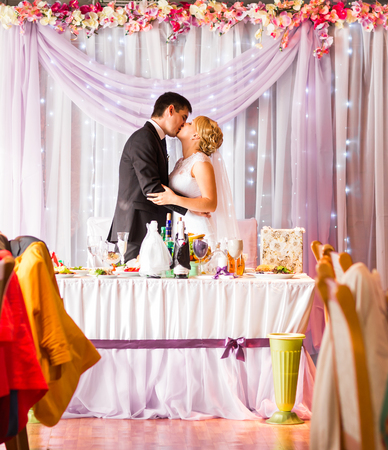 Bride And Groom Enjoying Meal At Wedding Reception.の写真素材