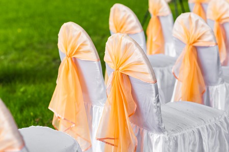 Row of chairs tastefully decorated for a part event.の写真素材