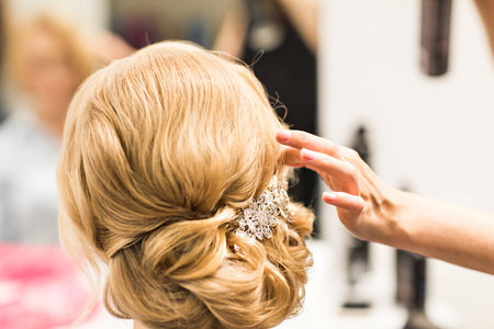 Portrait of attractive young woman with beautiful hairstyle and stylish hair accessory, rear viewの写真素材