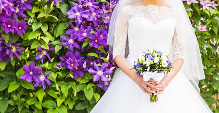 Beautiful wedding bouquet in hands of the bride.
