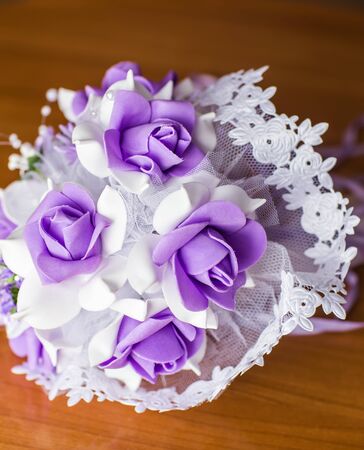 Beautiful purple artificial wedding bridal flowers bouquet.の写真素材