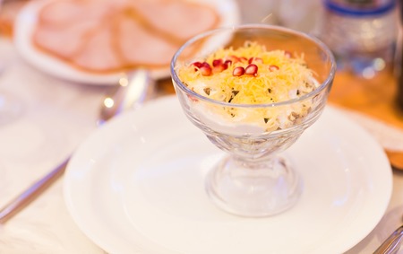 salad with cheese mushrooms and ham on festive tableの写真素材