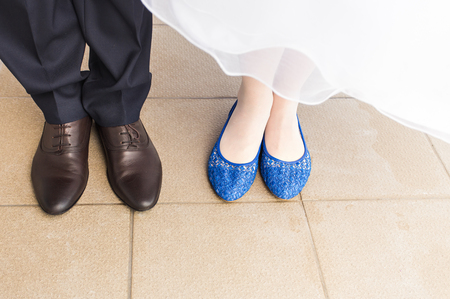 feet of bride and groom, wedding shoes close-up.の写真素材
