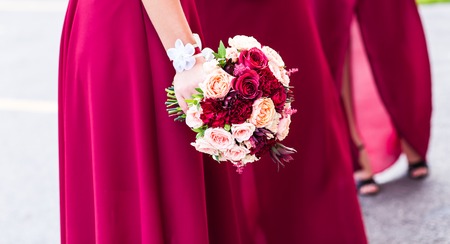 close up of woman hands with bouquet of flowersの写真素材