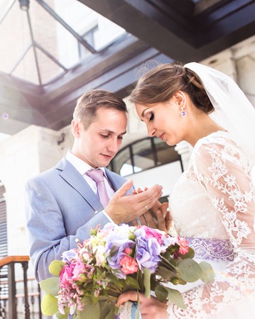 Bride and groom at wedding Day walking Outdoors on spring nature. Bridal couple, Happy Newlywed woman and man embracing in green park. Loving wedding couple outdoor. Bride and groomの写真素材
