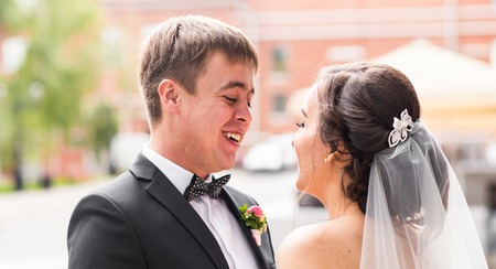 Bride and groom at wedding Day walking Outdoors on spring nature. Bridal couple, Happy Newlywed woman and man embracing in green park. Loving wedding couple outdoor. Bride and groomの写真素材