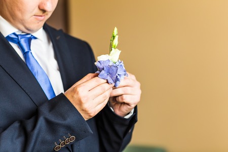 Wonderful wedding boutonniere on a costume of groom.の写真素材