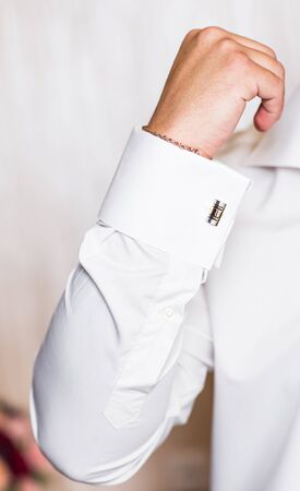 men or groom wear a shirt and cufflinks