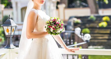 Wedding flowers ,Woman holding colorful bouquet with her hands on wedding day.の写真素材