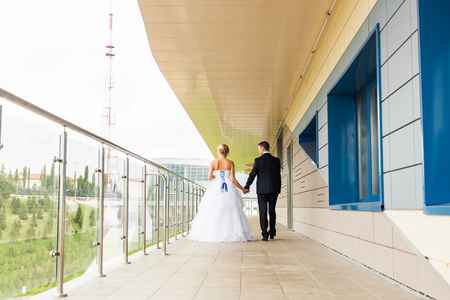 Bride and groom on their wedding day outdoors.の写真素材