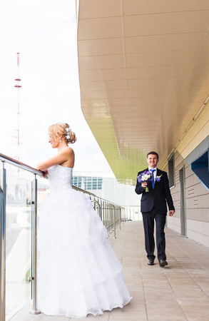 Bride and groom on their wedding day outdoors.の写真素材