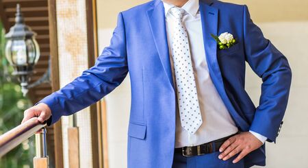 Handsome groom at wedding tuxedo smiling and waiting for bride. Happy smiling groom newlywed. Rich groom at wedding day. Elegant groom in tuxedo costume. Handsome caucasian man in tuxedo.の写真素材